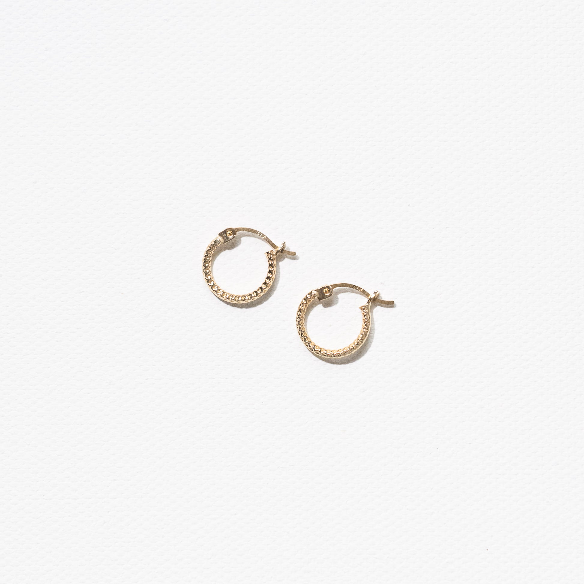 10 Karat Yellow Gold Textured Hoops Earrings by Athina Kadas. Crafted in Italy